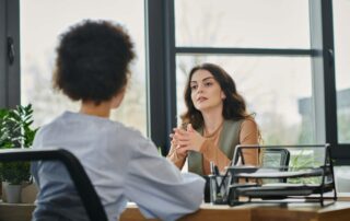 Two colleagues discuss elegant office setting